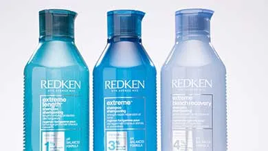 Three blue Redken bottles in a row