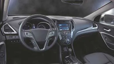 Modern car interior showing dashboard, steering wheel, center console, and seats with a clean, matte finish.