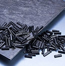 black long fiber pellets on black composite board